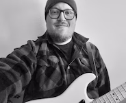 Anker Peet, of the band Mr. Gentleman, posing with a guitar.